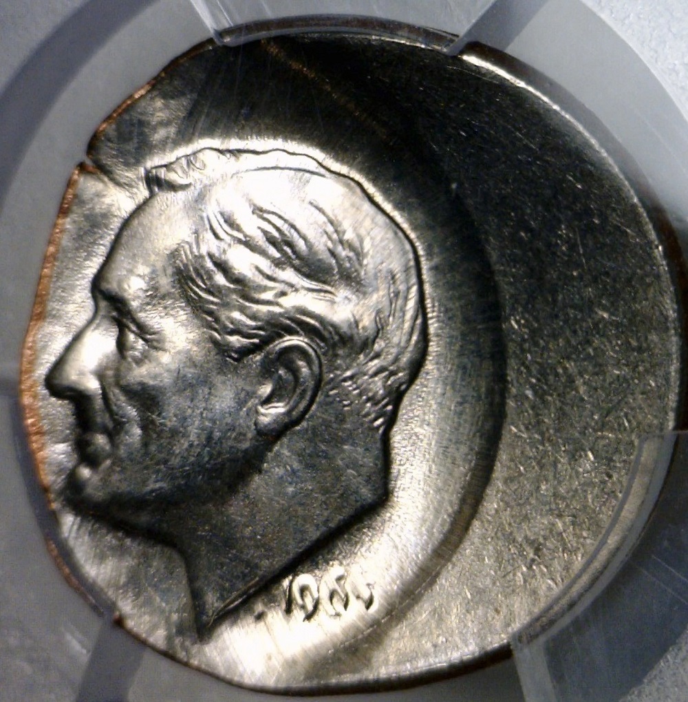 1968 Roosevelt dime struck off-center showing large blank crescent area and partial design with visible date